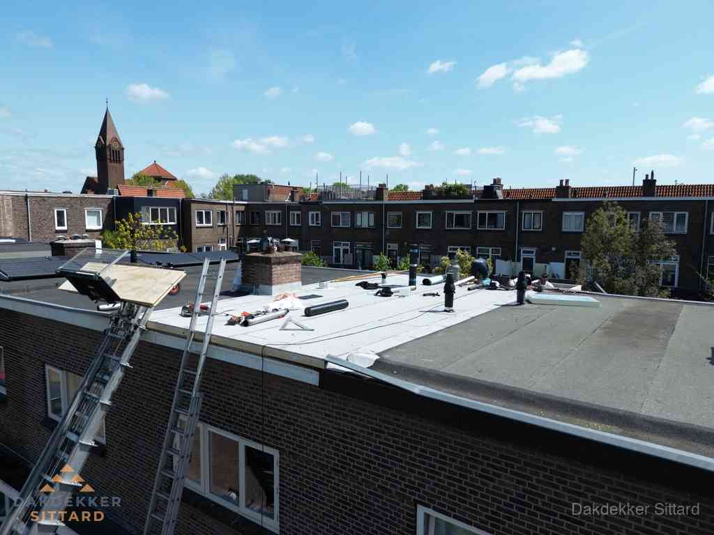 Dakdekkers aan het werk op plat dak in Sittard